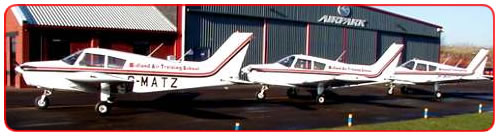 Midland Air Training's three Piper Cherokees lined up outside the Airpark hangar at Coventry Airport